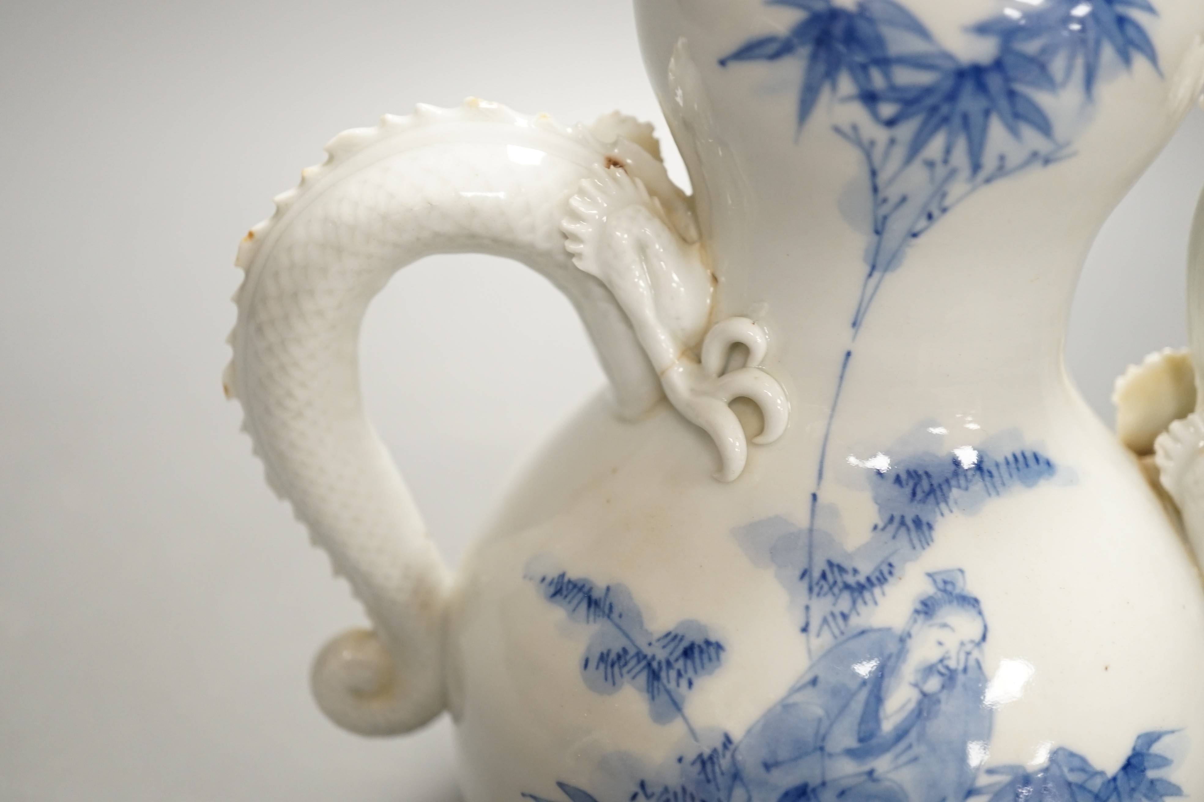 A Japanese Hirado blue and white 'dragon' wine pot, late 19th century, of double gourd shape, (losses) 19.5cm